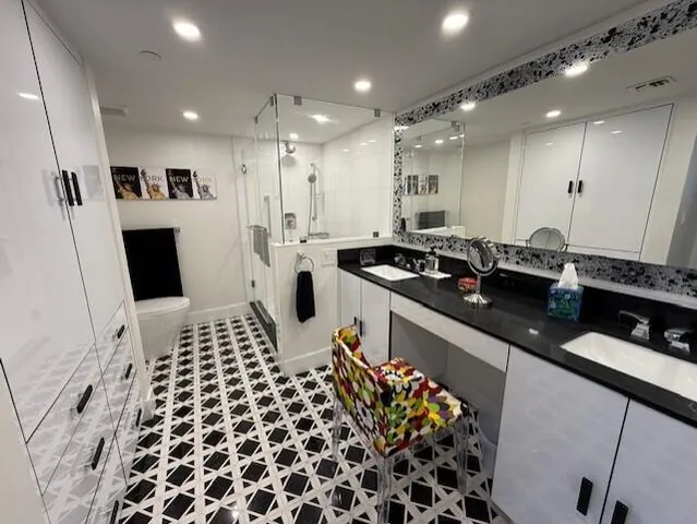 a large kitchen with a sink and stainless steel appliances