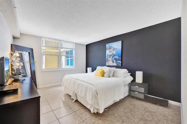 a bedroom with a bed and dresser