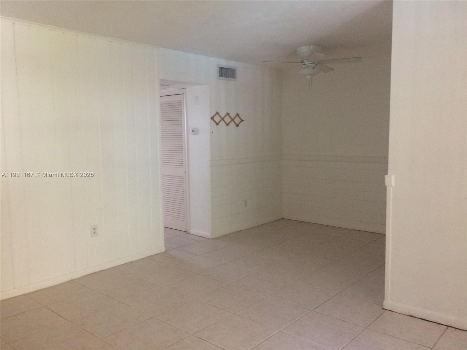 255 Sunrise Drive, Unit 103 Key Biscayne, FL 33149 - Photo 2 of 11 an empty room with a glass door