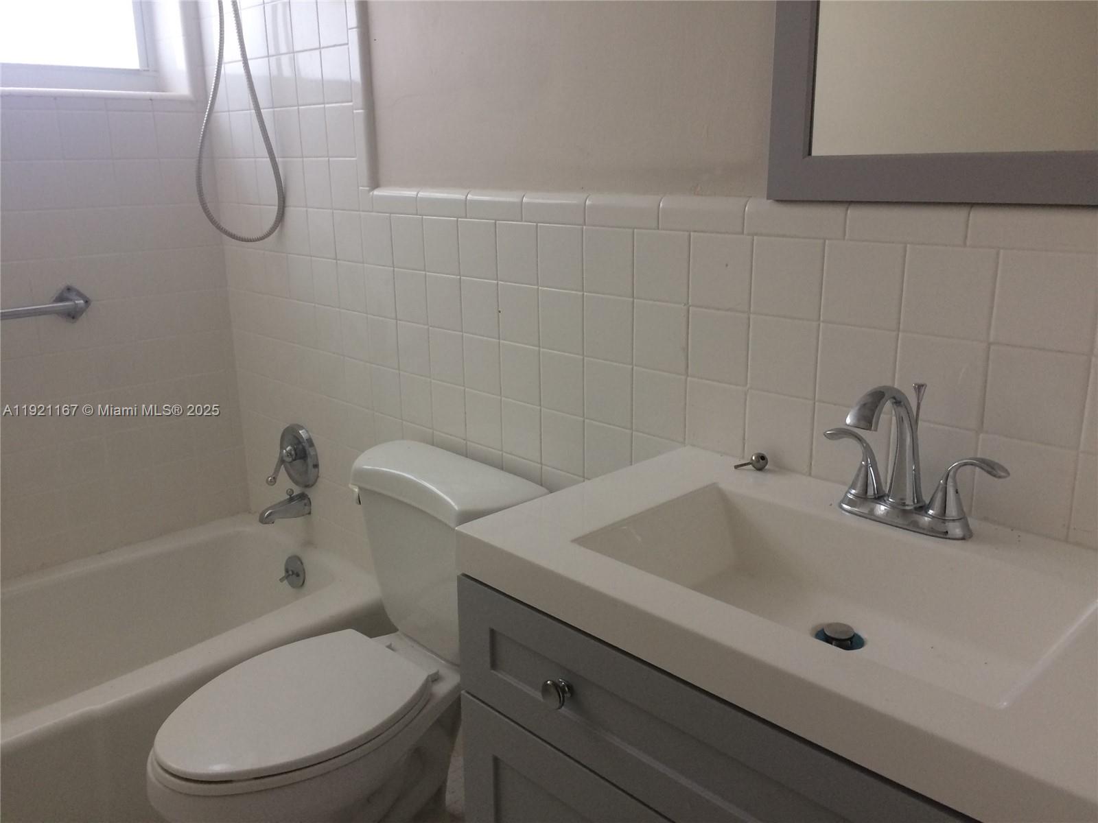 255 Sunrise Drive, Unit 103 Key Biscayne, FL 33149 - Photo 5 of 11 a bathroom with a sink a toilet and shower