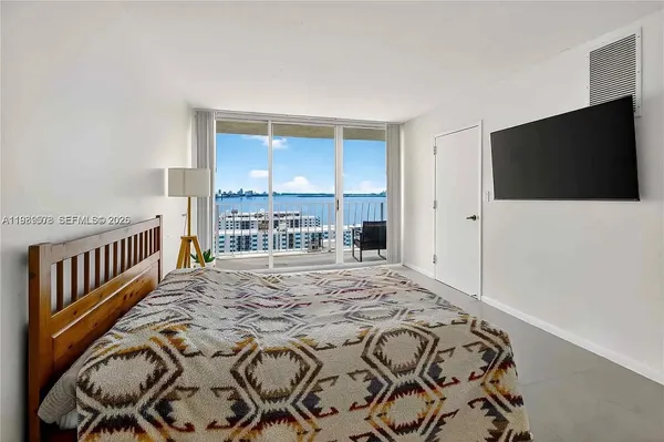 a kitchen with stainless steel appliances a stove a sink and white cabinets with wooden floor