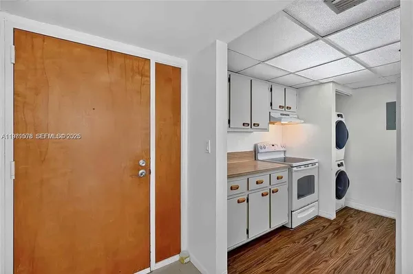 a bathroom with a granite countertop sink a toilet a mirror and shower