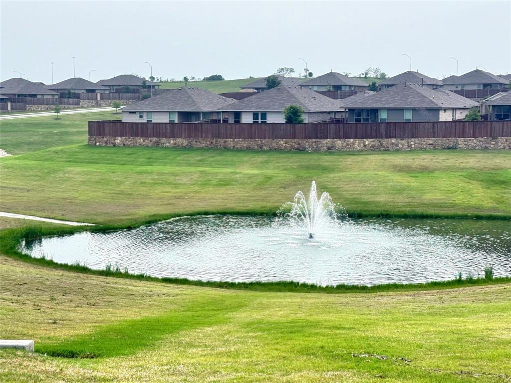 9604 Cherryville Road Fort Worth, TX 76108 - Photo 34 of 40 Community pond with a decorative fountain which backs up to the home creating calming waterfall splashing sound.
