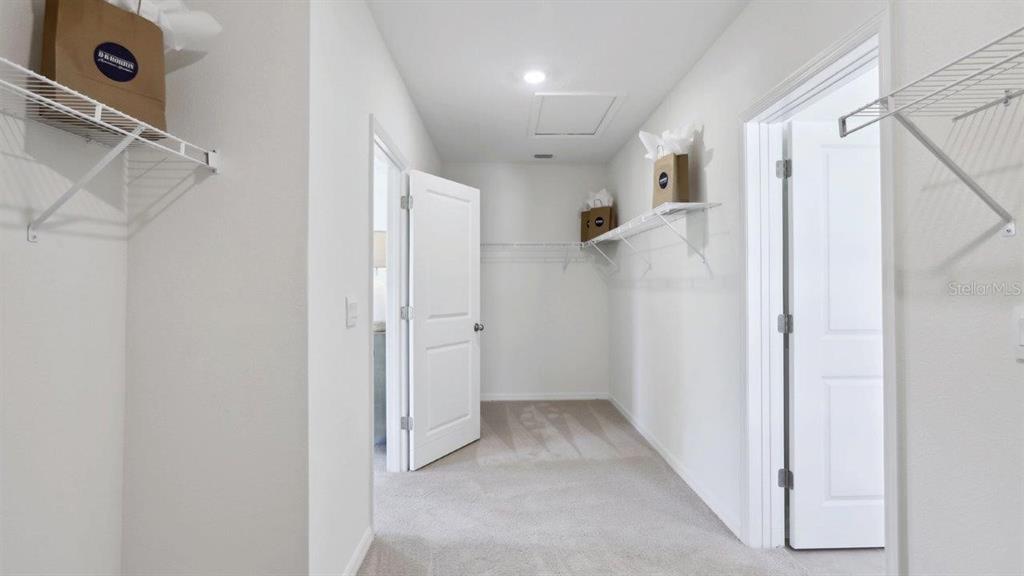 17536 Acorn Drop Road Land O Lakes, FL 34638 - Photo 26 of 28 a view of hallway with stairs and a chandelier