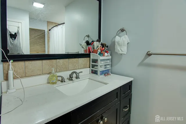 a bathroom with a sink and a mirror