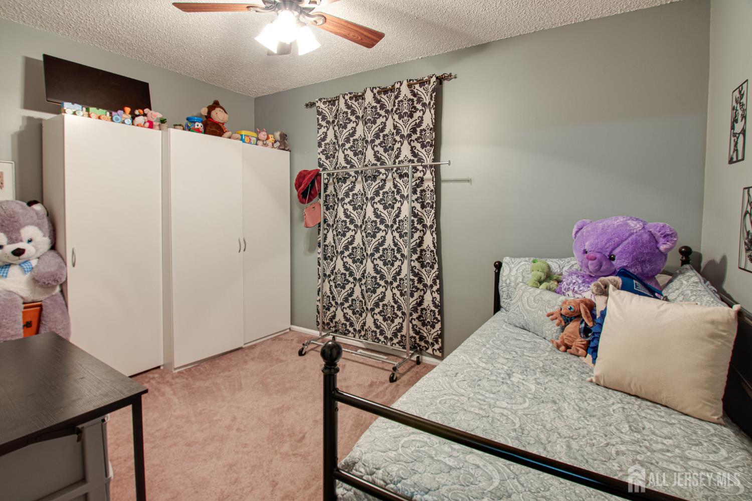 2 Fieldcrest Way Freehold, NJ 07728 - Photo 18 of 24 a bedroom with a bed and a dresser in it