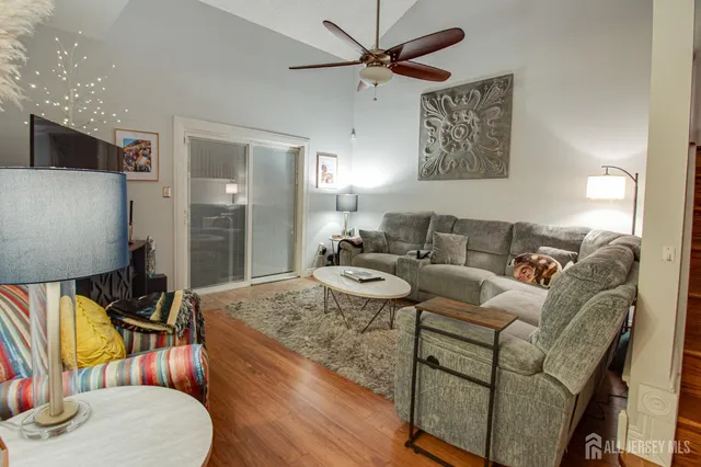 a living room with furniture and a wooden floor