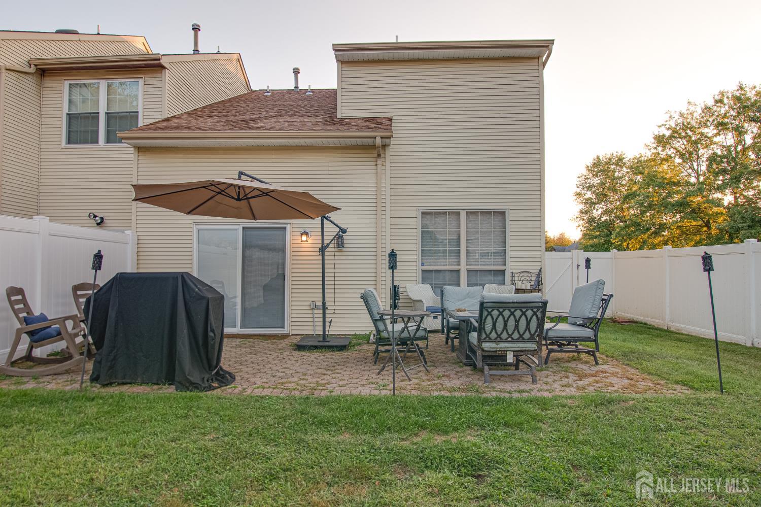 2 Fieldcrest Way Freehold, NJ 07728 - Photo 20 of 24 a patio with table and chairs and a barbeque