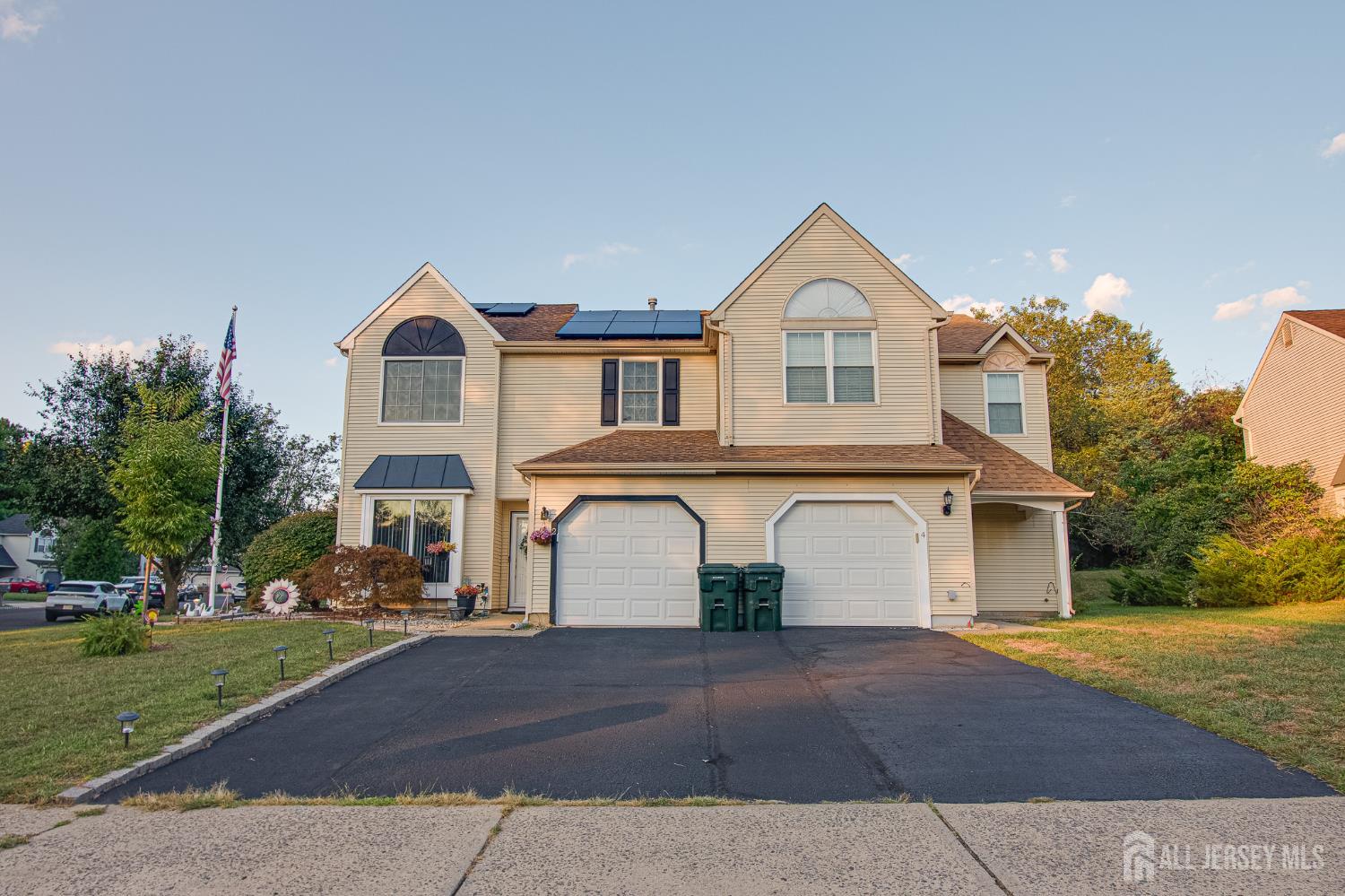 2 Fieldcrest Way Freehold, NJ 07728 - Photo 2 of 24 a front view of a house with a yard and garage