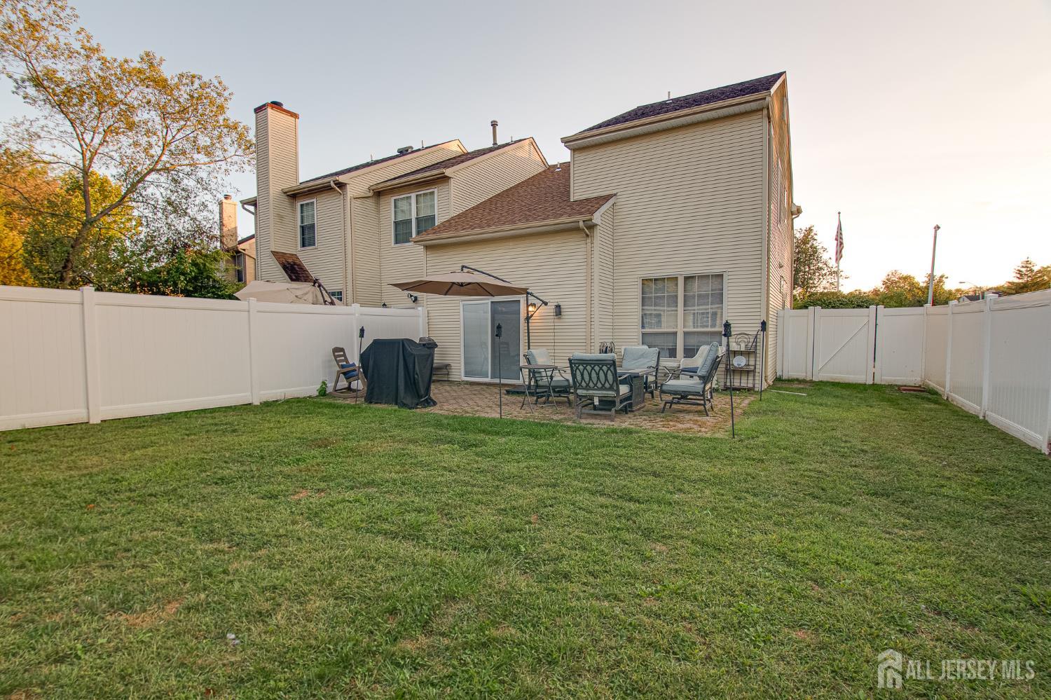 2 Fieldcrest Way Freehold, NJ 07728 - Photo 21 of 24 a backyard of a house with table and chairs