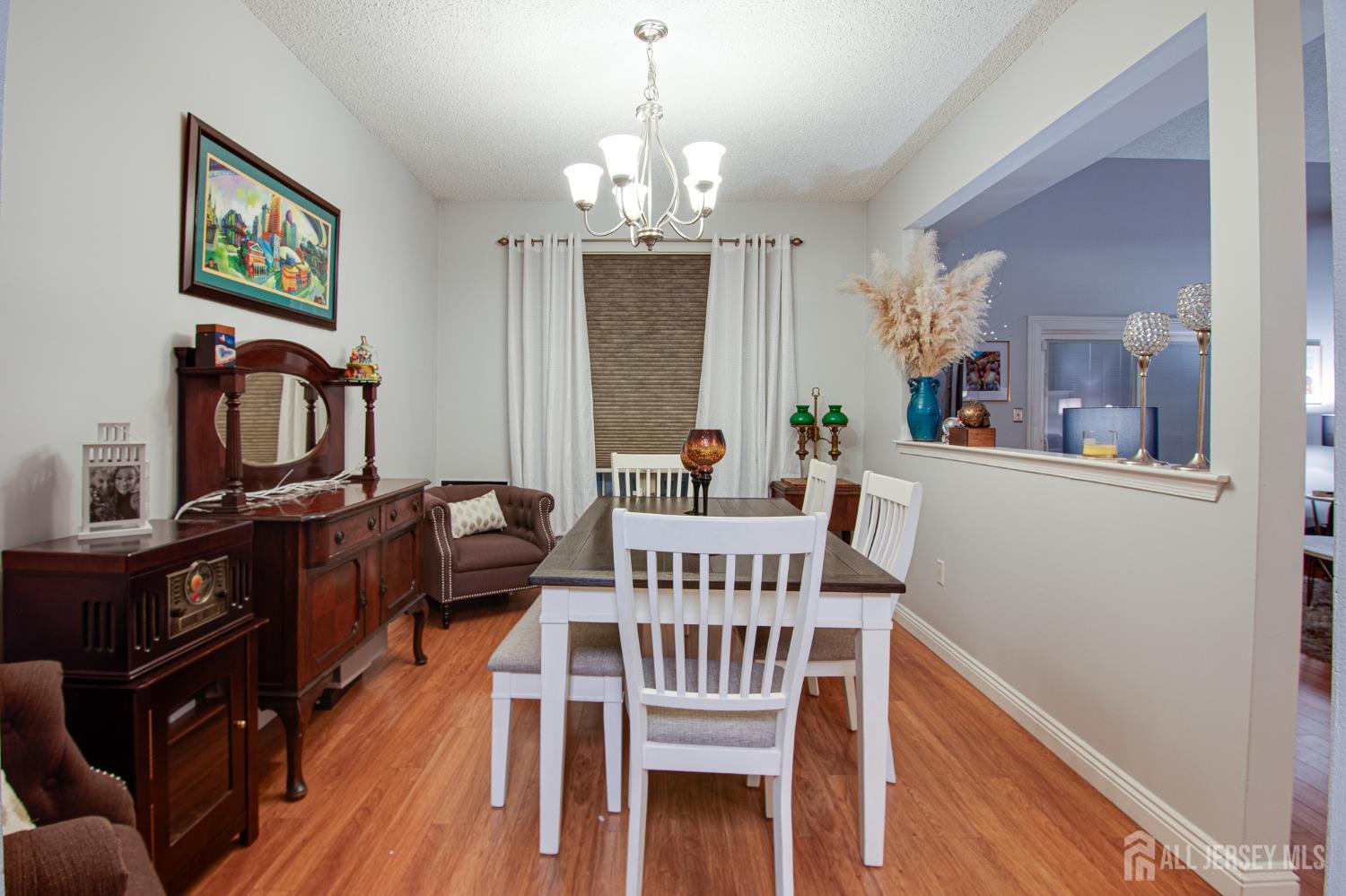 2 Fieldcrest Way Freehold, NJ 07728 - Photo 9 of 24 a view of a dining room with furniture a chandelier and wooden floor