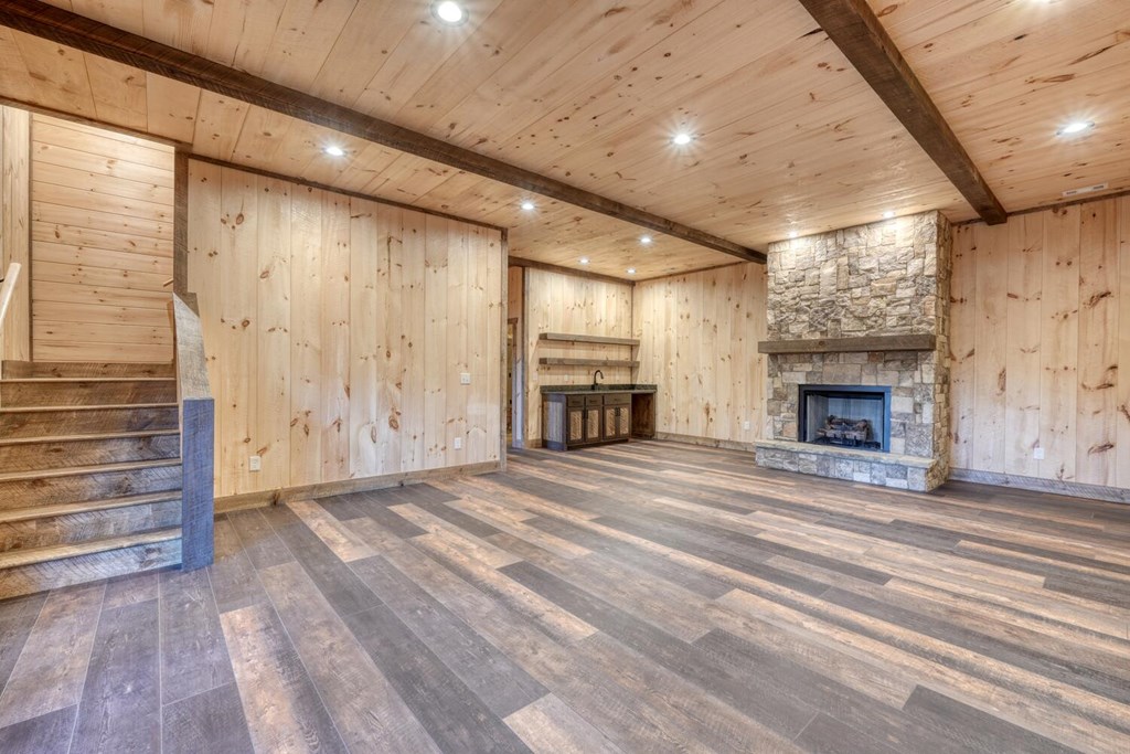 250 Wolfcreek Road Mineral Bluff, GA 30559 - Photo 20 of 59 an empty room with wooden floor fireplace and windows