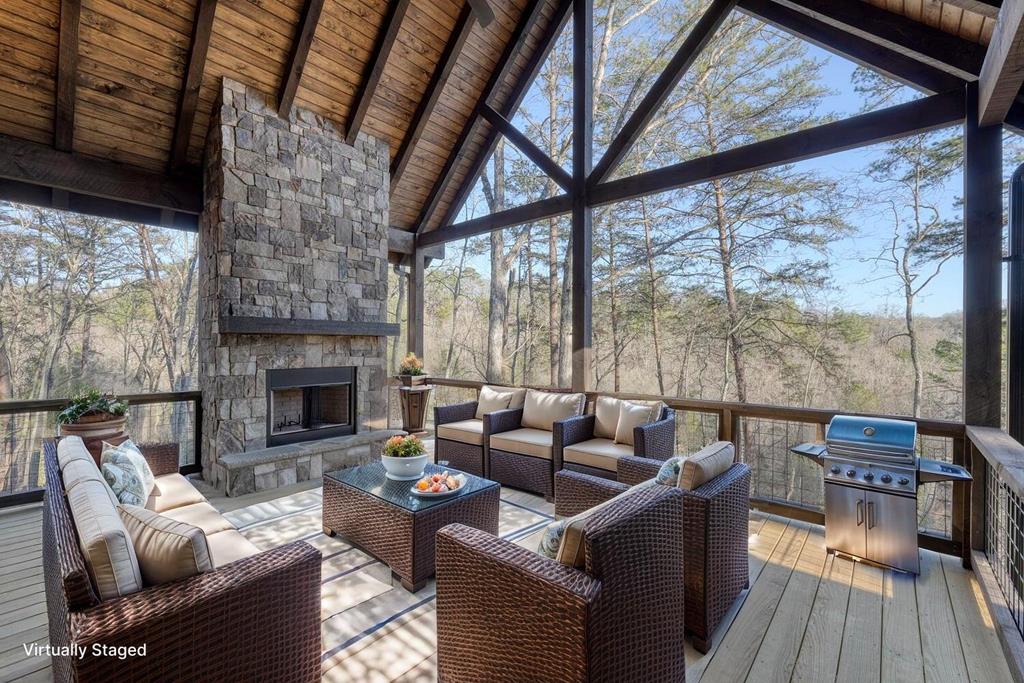 250 Wolfcreek Road Mineral Bluff, GA 30559 - Photo 3 of 59 a living room with furniture a fireplace and a floor to ceiling window