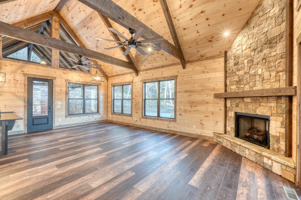 250 Wolfcreek Road Mineral Bluff, GA 30559 - Photo 31 of 59 a view of an empty room with wooden floor and a fireplace