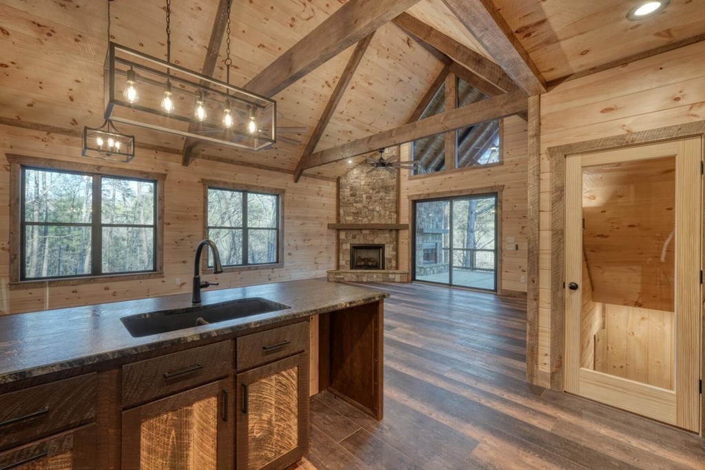250 Wolfcreek Road Mineral Bluff, GA 30559 - Photo 36 of 59 a kitchen with granite countertop a sink window and wooden floor