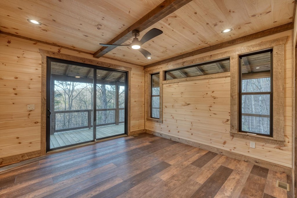 250 Wolfcreek Road Mineral Bluff, GA 30559 - Photo 38 of 59 an empty room with wooden floor and windows