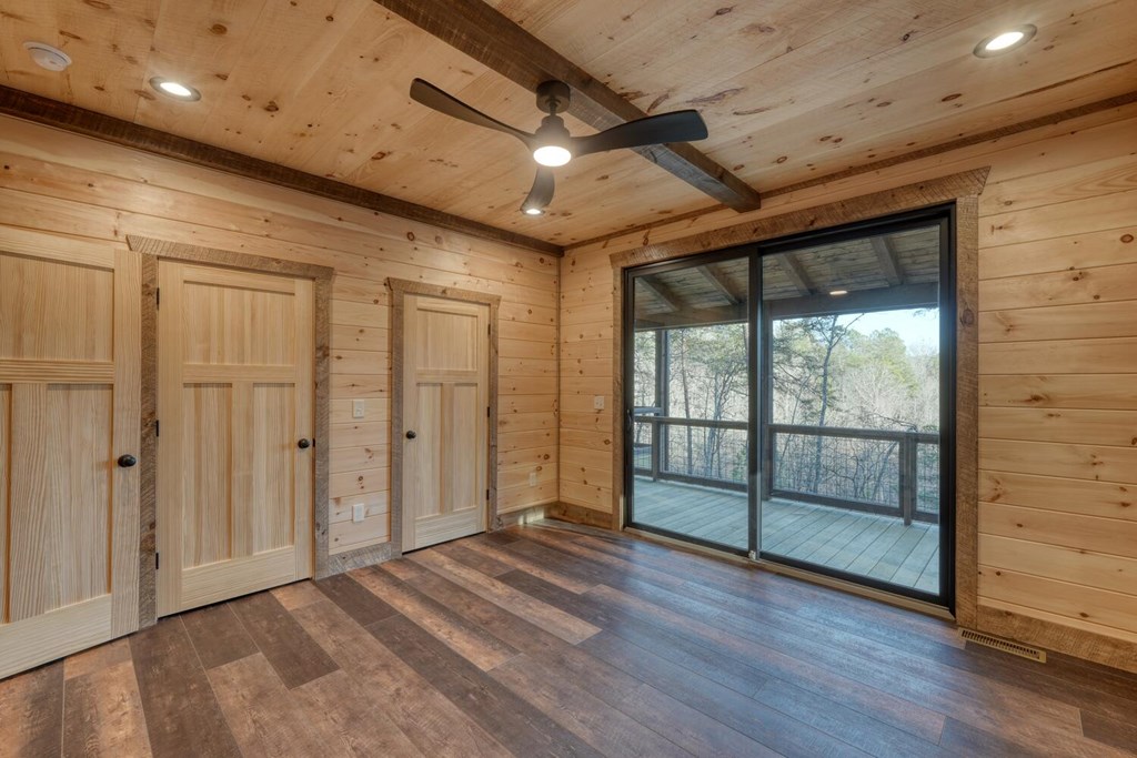 250 Wolfcreek Road Mineral Bluff, GA 30559 - Photo 39 of 59 en empty room with wooden floor and sliding door