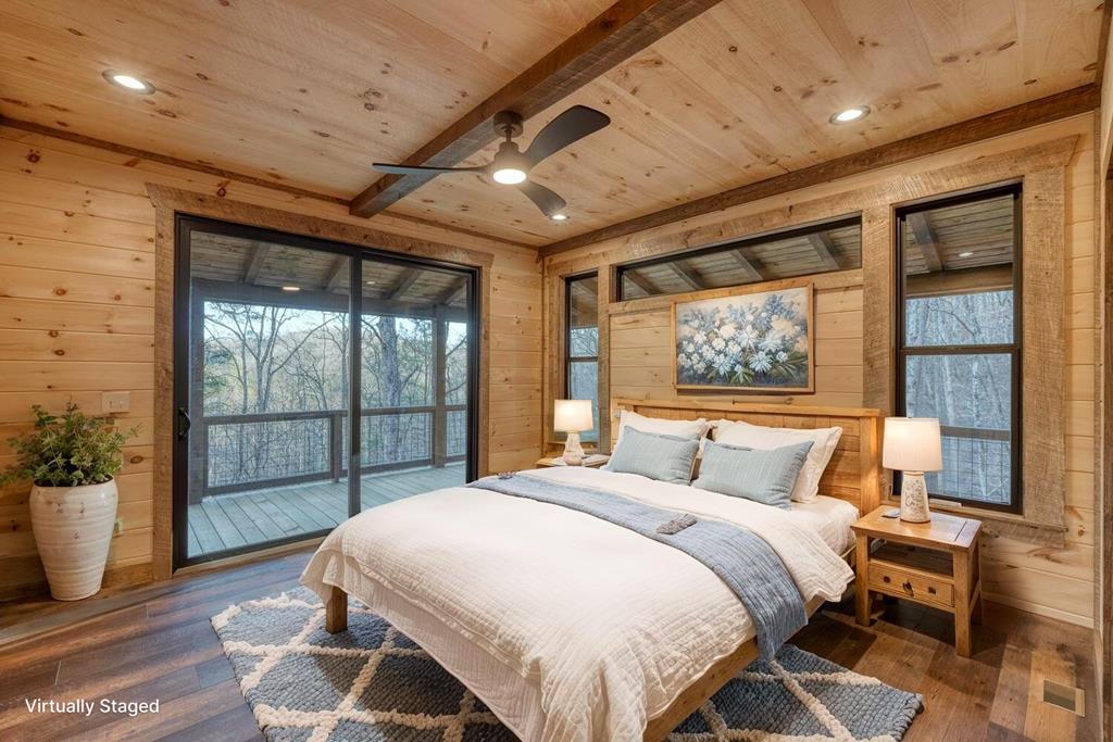 250 Wolfcreek Road Mineral Bluff, GA 30559 - Photo 5 of 59 a bedroom with a large bed and a potted plant
