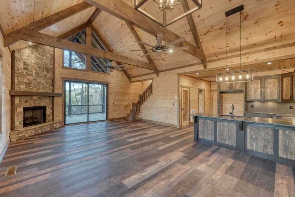 250 Wolfcreek Road Mineral Bluff, GA 30559 - Photo 9 of 59 a view of a hall with wooden floor and a fireplace
