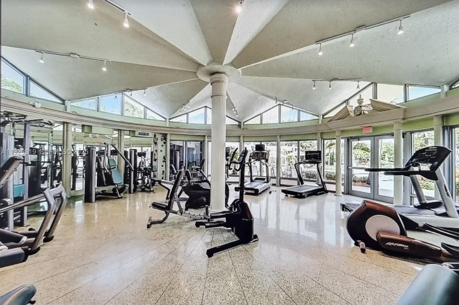 5055 Collins Avenue, Unit 10F Miami Beach, FL 33140 - Photo 17 of 24 a view of a room with gym equipment