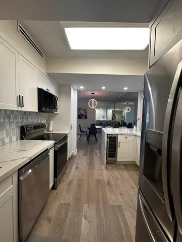 a bathroom with a sink a toilet a mirror and shower