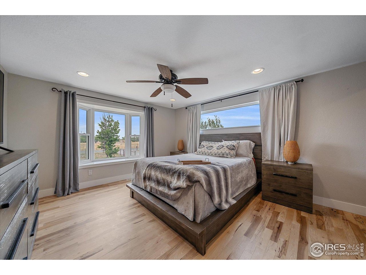 11724 Kenosha Road Longmont, CO 80504 - Photo 21 of 49 Primary bedroom with bay window, bench and picture window above bed