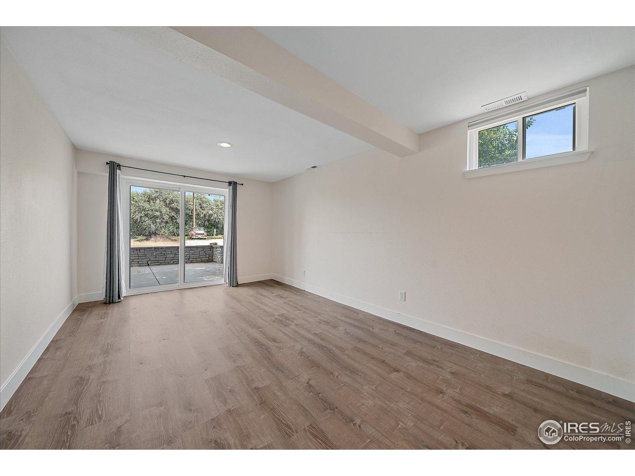 11724 Kenosha Road Longmont, CO 80504 - Photo 33 of 49 Bedroom with sliding glass door and access to a patio
