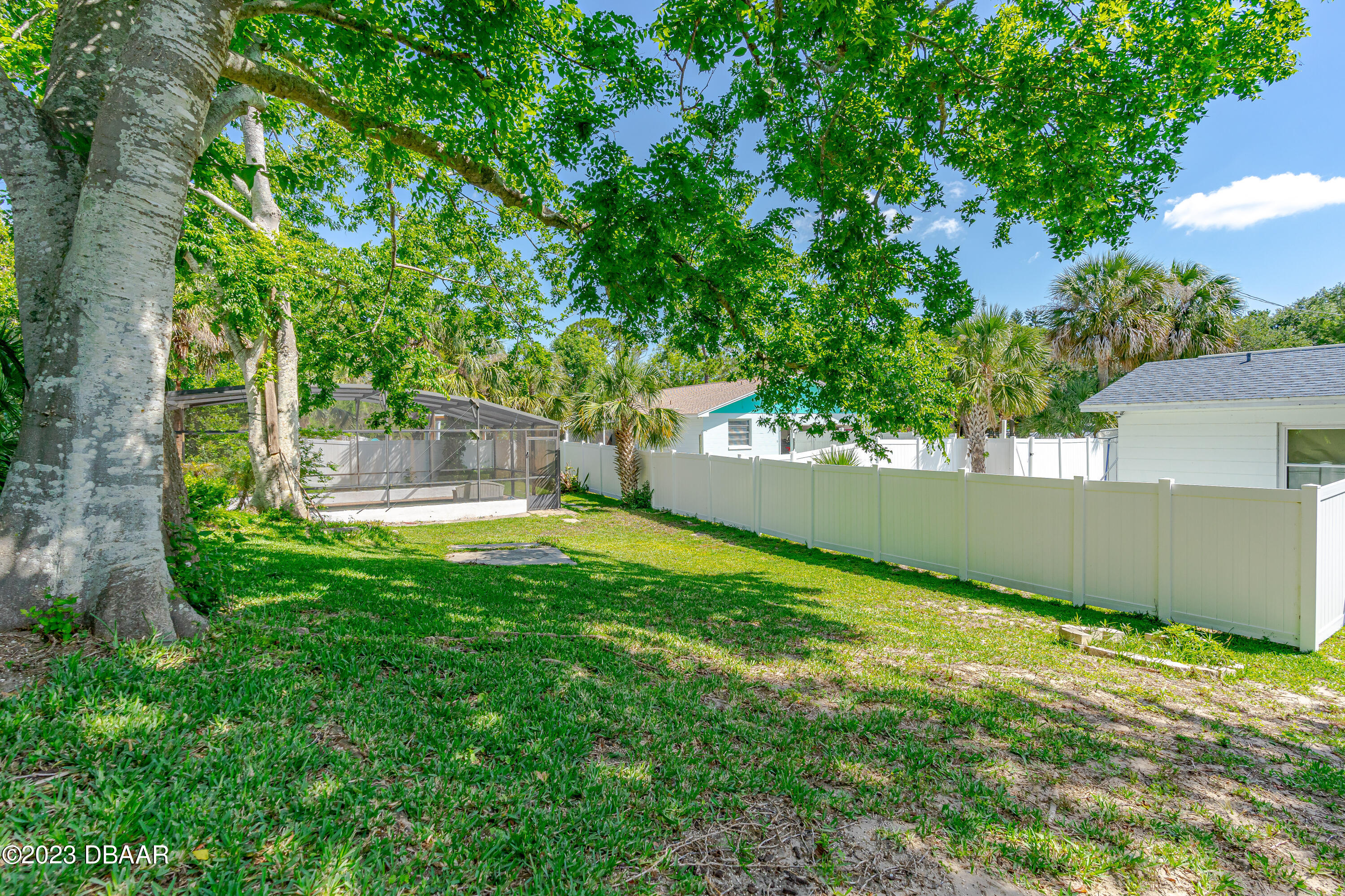 75 Seminole Avenue Ormond Beach, FL 32176 - Photo 11 of 59 a view of a backyard with a small cabin