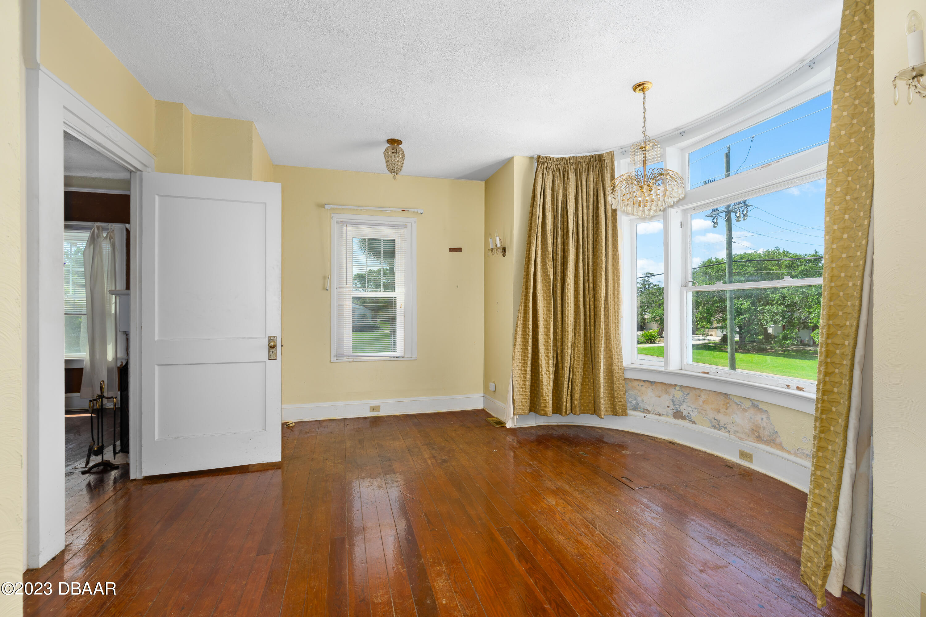 75 Seminole Avenue Ormond Beach, FL 32176 - Photo 22 of 59 a view of a big room with wooden floor and windows