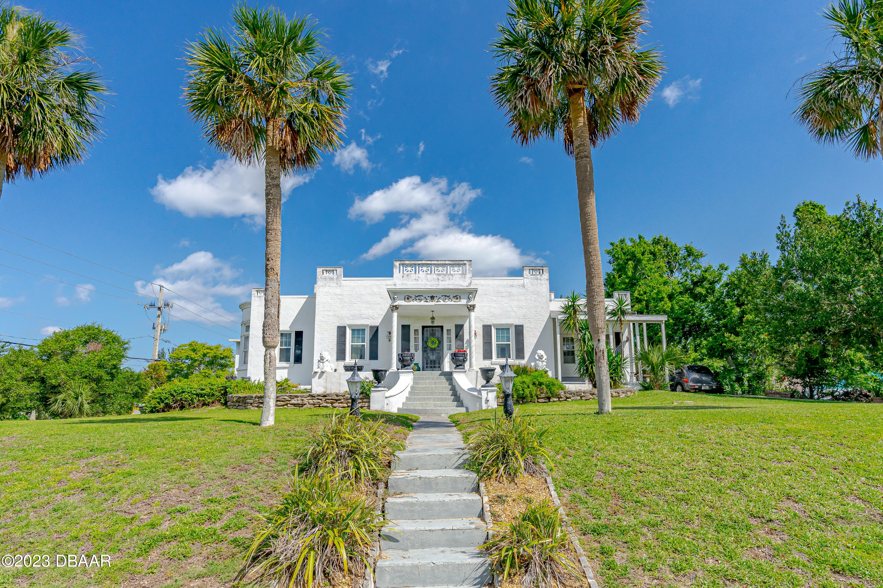 75 Seminole Avenue Ormond Beach, FL 32176 - Photo 3 of 59 a view of a fountain in front of house with palm trees