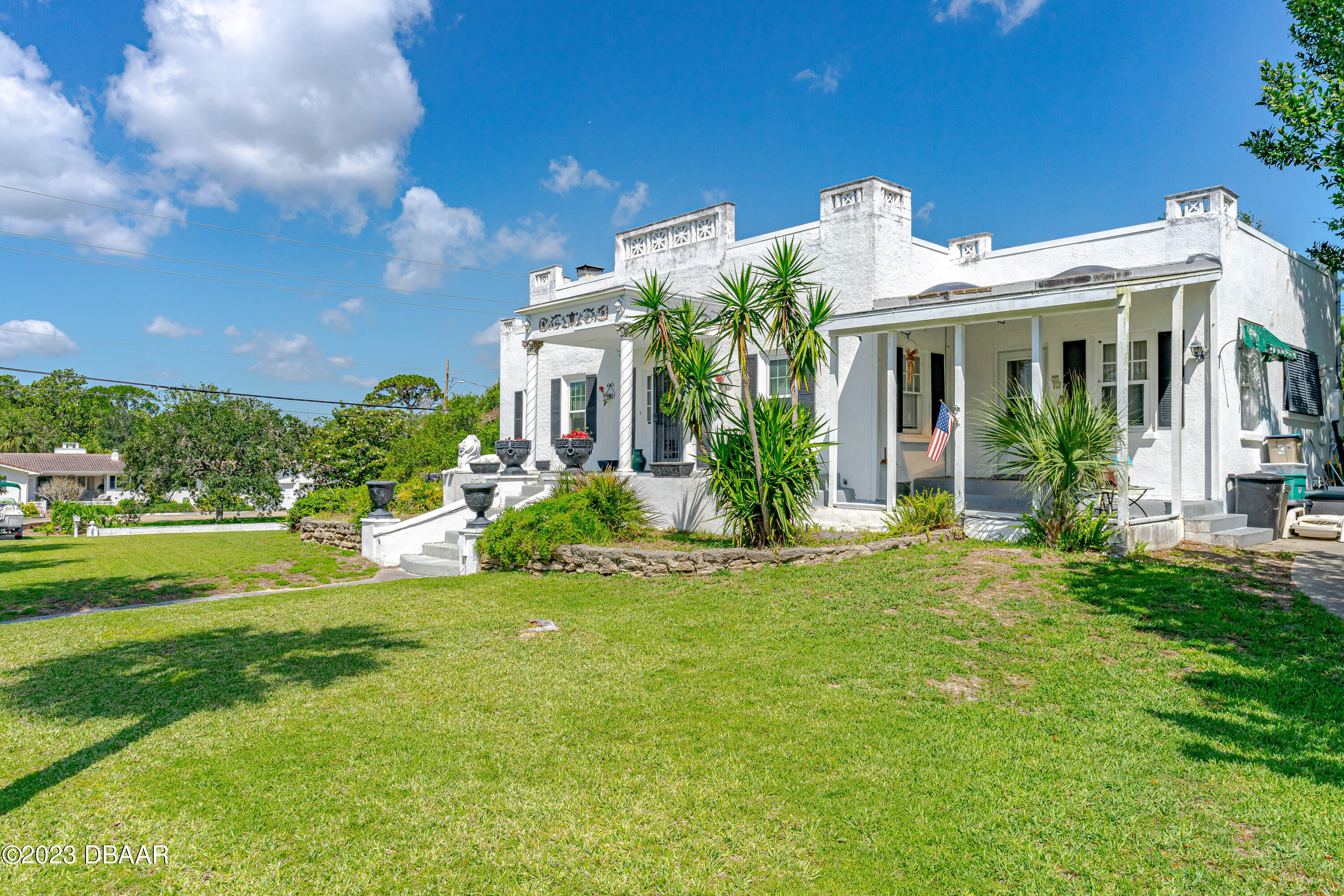 75 Seminole Avenue Ormond Beach, FL 32176 - Photo 5 of 59 a front view of a house with a garden and plants