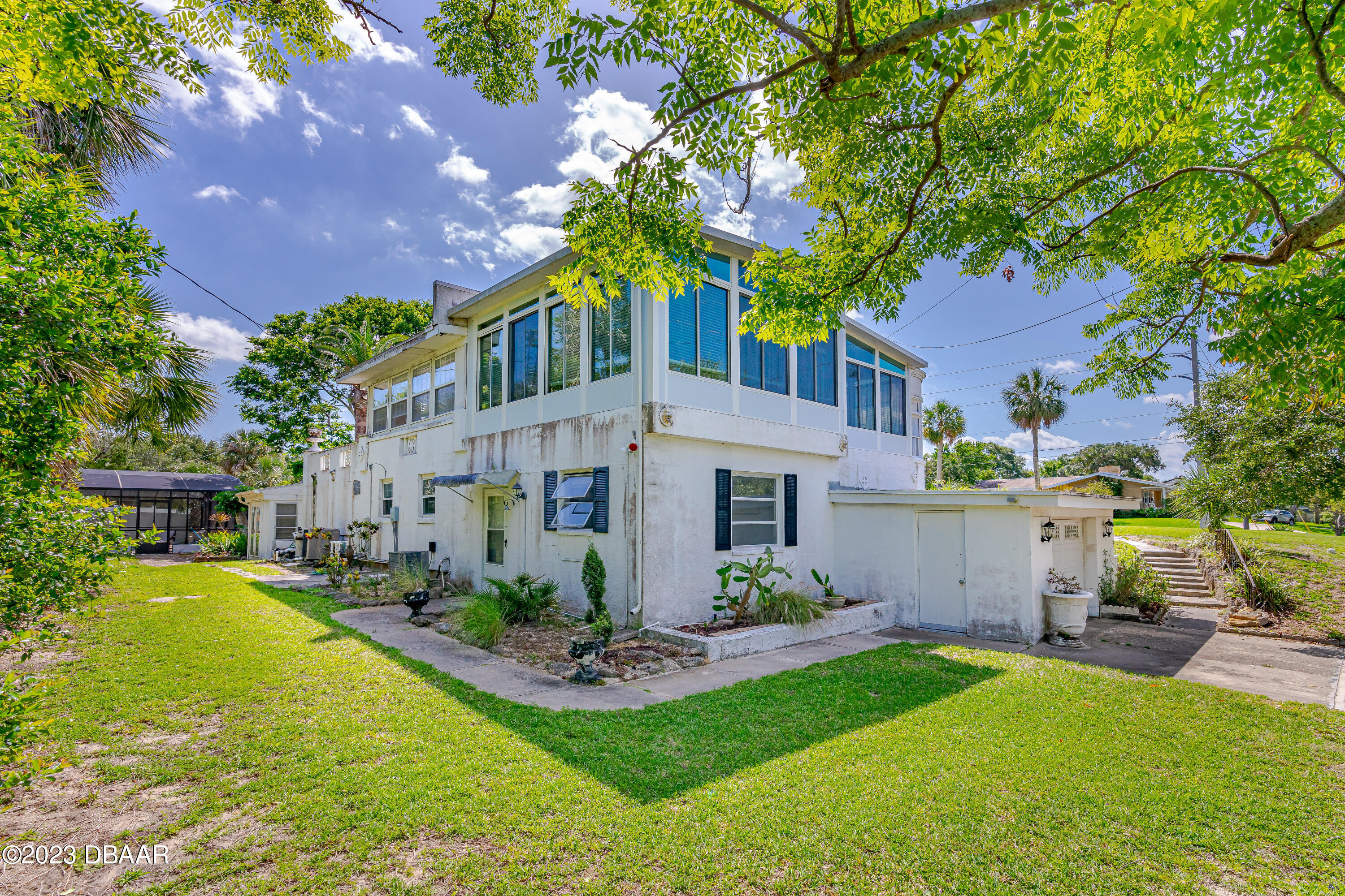 75 Seminole Avenue Ormond Beach, FL 32176 - Photo 6 of 59 a front view of a house with a yard table and chairs