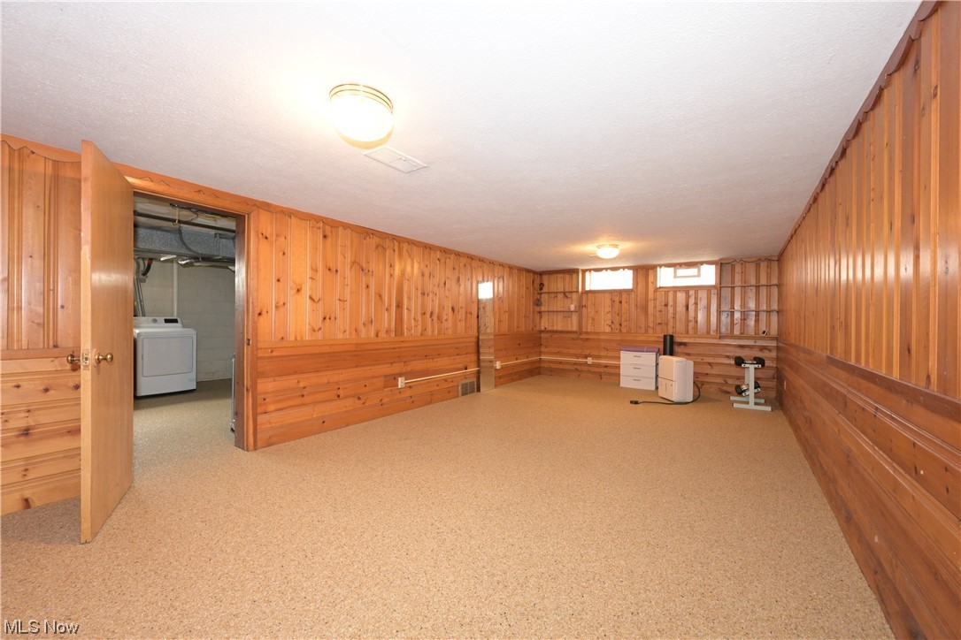 3798 Hillbrook Road Cleveland, OH 44118 - Photo 30 of 34 Basement with light colored carpet, washer / clothes dryer, and wood walls