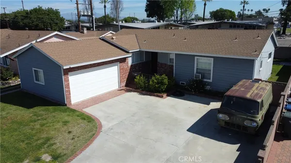 a aerial view of a house with a yard and garage