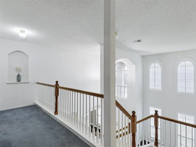 a view of a hallway with entryway window and stairs