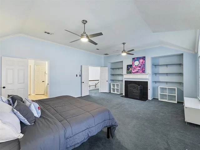 a spacious bedroom with a bed and a fireplace