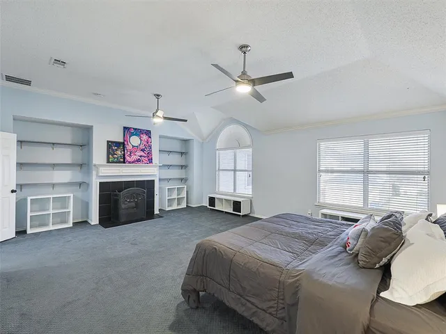 a spacious bedroom with a bed closet and a window