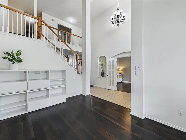 a view of a hallway with wooden floor and entryway