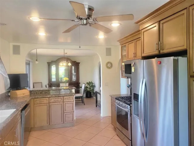 a kitchen with stainless steel appliances a refrigerator a sink a stove and cabinets