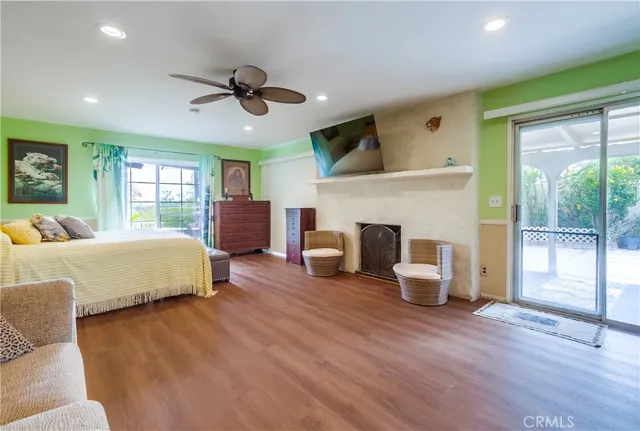 a spacious bedroom with a large bed and a chandelier