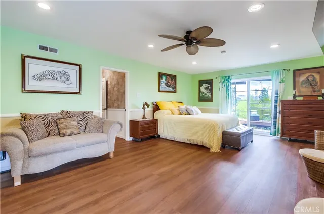 a bed room with furniture and a large window