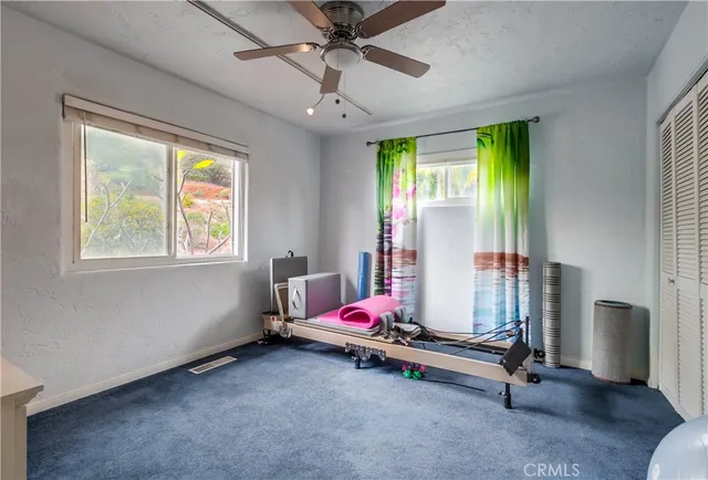 a room with gym equipment and windows