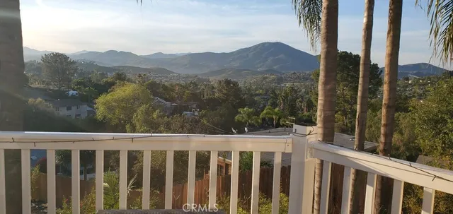 a view of a balcony with wooden fence and floor