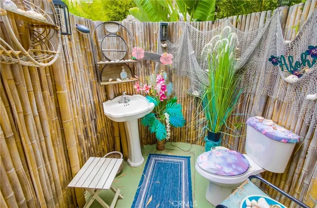 a bathroom with a sink toilet and a mirror