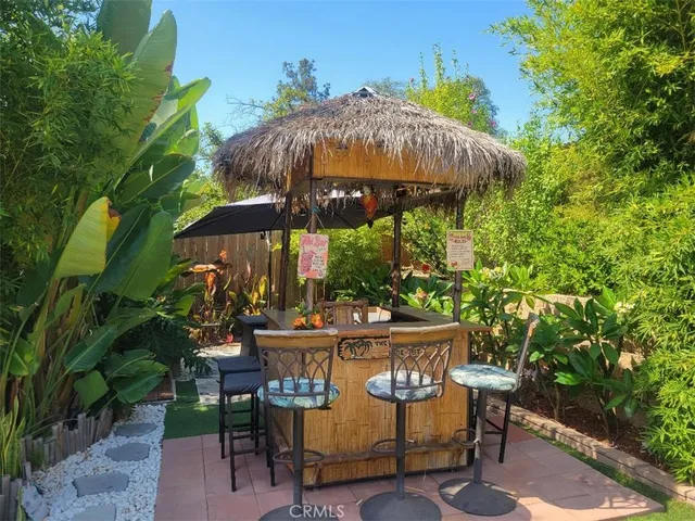 a view of patio with a table and chairs under an umbrella