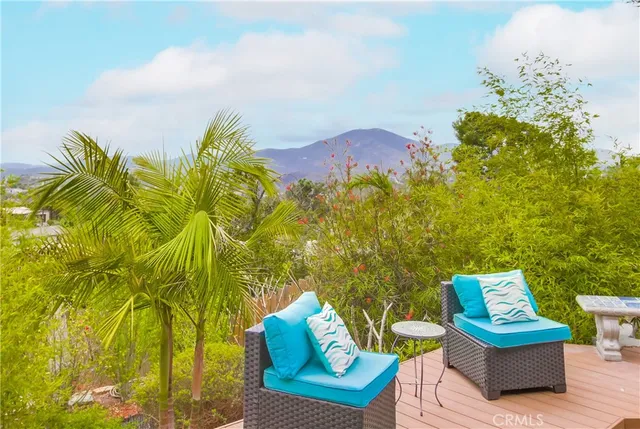 a view of a chairs and table in a backyard