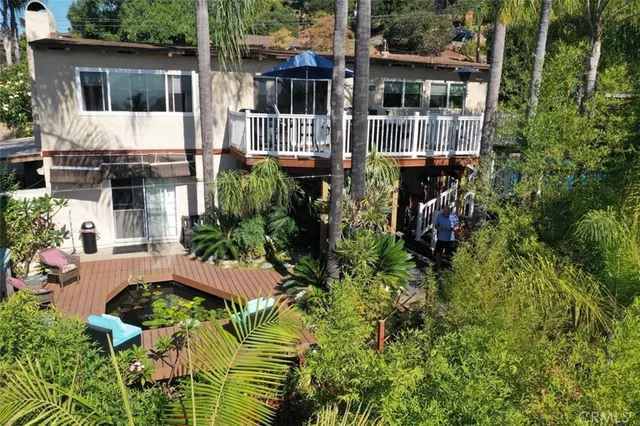 an aerial view of a house with balcony and garden