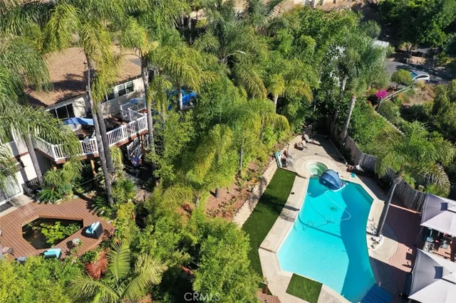 an aerial view of a house with a yard and garden