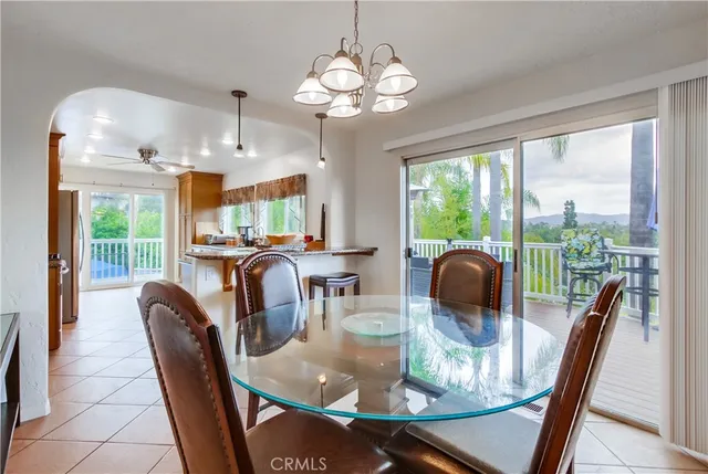 a dining room with furniture a large window and outside view