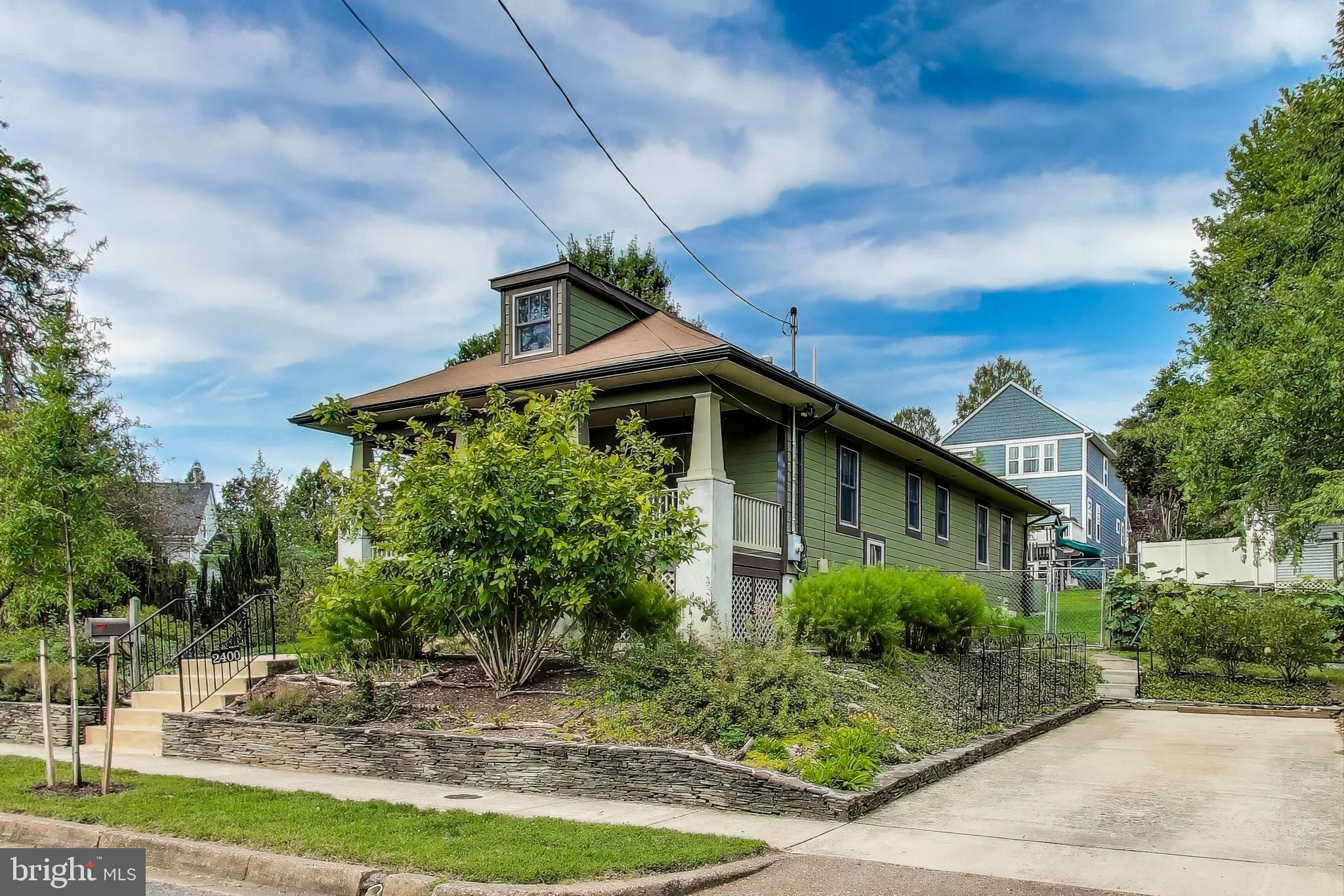 2400 Valley Way Cheverly, MD 20785 - Photo 41 of 42 Craftsman-style home with lush greenery and sky.